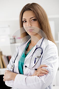 Female medicine doctor standing with her arms crossed