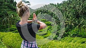 Female meditating on Tegalalang Rice Terrace, Ubud, Bali, Indonesia