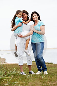 Female Members Of Multi Generation Family Standing By Sea