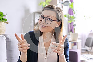 Female mentor, tutor, teacher looking at webcam of laptop, closeup face