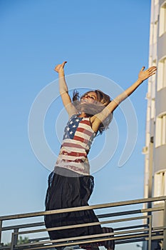 Female model on the background of sky in a t-shirt with the Amer