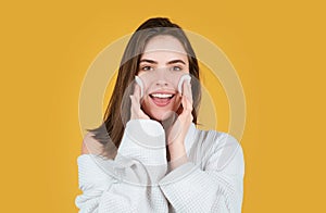 Female model holding gentle facial sponge for morning daily exfoliation. Beauty woman with clean healthy skin, natural