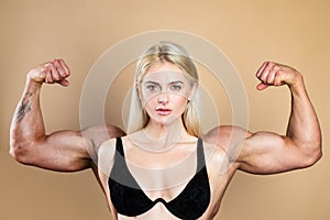 Female model keeps fit and healthy, raises hands and shows muscles, power. Strong muscle arms. Funny sport, woman with