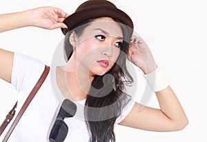 Female model pose with holding cap