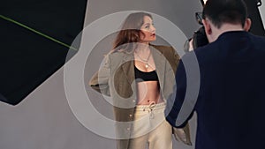 A female model poses for a male photographer.