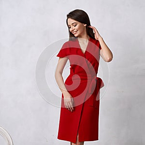 Female model in red wrap around midi dress