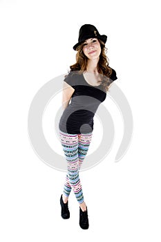 Female model wearing heels, cut hat and colorful leggings