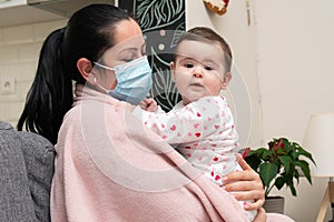 Female model wearing surgical mask hugging cute baby child