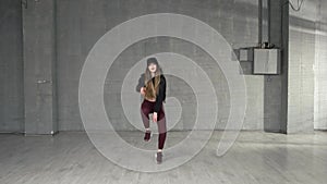 Female modern style dancer dancing in studio.