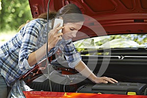 Female Motorist Phoning For Help After Breakdown photo