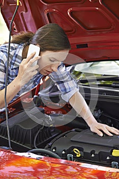 Female Motorist Phoning For Help After Breakdown