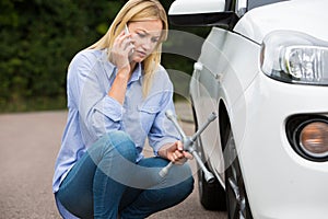 Female Motorist Phoning For Help After Breakdown