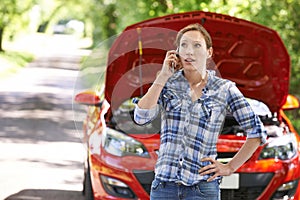 Female Motorist Phoning For Help After Breakdown
