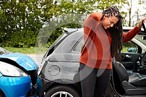 Female Motorist With Whiplash Injury In Car Crash Getting Out Of Vehicle