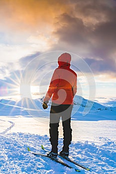 Female mountaineer and explorer enjoying a witner sunset