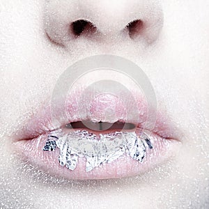 Female mouth with sparkles on lips. Closeup beauty portrait of
