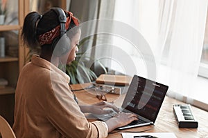 Female Musician Making Music on Laptop