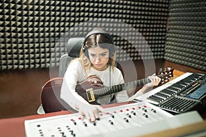 Female musician making new jingle in recording room