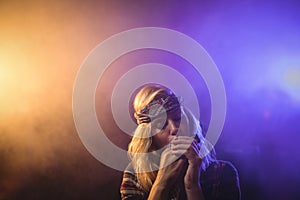 Female musician playing harmonica in nightclub photo