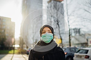 Female Muslim with protective surgical mask.Hijab woman wearing mask in the city.Coronavirus COVID-19 pandemic lifestyle in