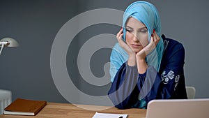 Female muslim student learning at home