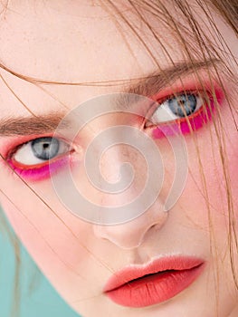 Female natural blue eyes and face with beautiful freckles and healthy skin