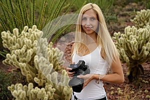 Female nature photographer taking photos of the saguaro cactus Carnegiea gigantea in Saguaro National Park, Arizona