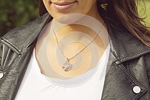 Female neckline wearing tiny silver chain with silver pendant