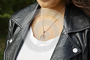 Female neckline wearing tiny silver chain with silver pendant