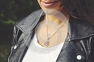 Female neckline wearing tiny silver chain with silver pendant