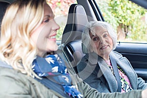 Female Neighbor Giving Senior Woman A Lift In Car