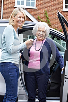 Female Neighbor Giving Senior Woman A Lift In Car