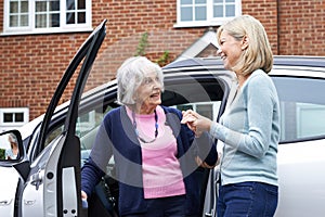 Female Neighbor Giving Senior Woman A Lift In Car