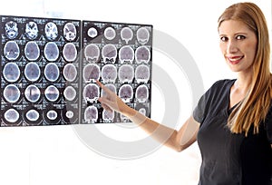 Female neurologist specialist professional doctor with mask reviewing brain scans