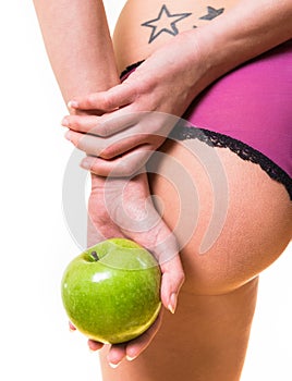 Female with nice buttocks and apple in hand