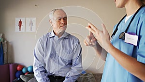 Female nurse advising elderly man on healthy lifestyle.