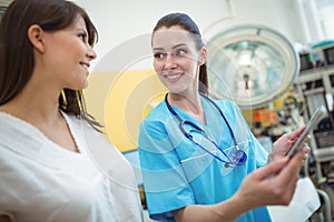 Female nurse assisting patient on digital tablet