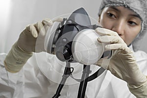 Female nurse or doctor checking a mask respirator