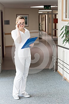 female nurse or doctor in the corridor of an hospital or retirement resistence photo