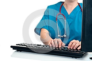 A female nurse/doctor entering data