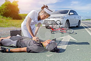 Female nurse helping emergency CPR to asia cyclist injured