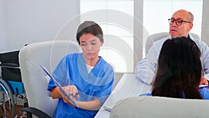 Female nurse holding clipboard explaining diagnosis