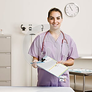 Female nurse holding out forms