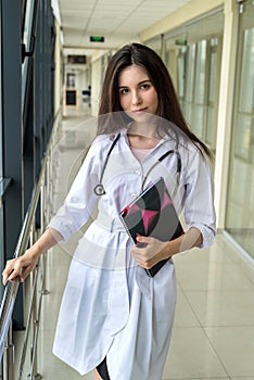 Female nurse holding patient medical history in notebook