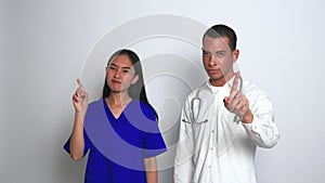 A Female Nurse and a Male Doctor Doing Disagree Gesture on a White Background