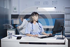 Female nurse typing a medical report