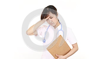 A female nurse who has a headache