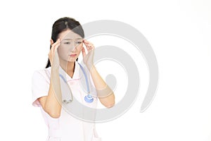 A female nurse who has a headache