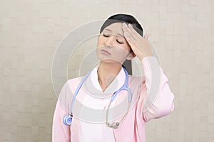 A female nurse who has a headache