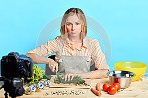 Female nutrition expert chopping fresh vegetables, cooking dietary meal